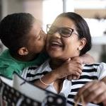 Patelco member Jane gets a kiss on the cheek from her son.